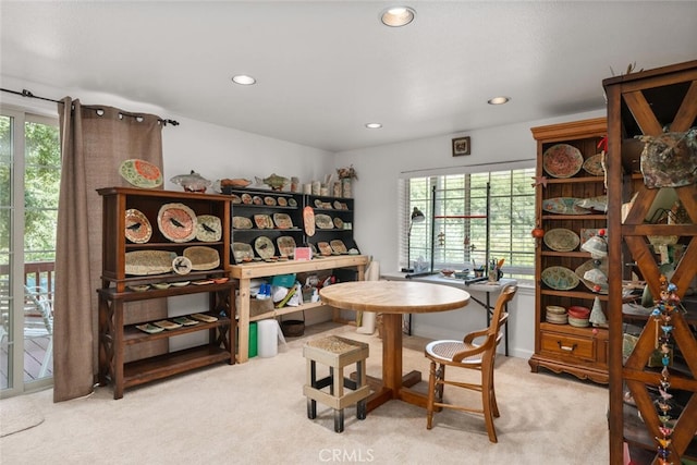 dining room with recessed lighting, a wealth of natural light, and light colored carpet