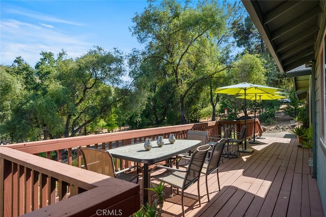 wooden terrace with outdoor dining space