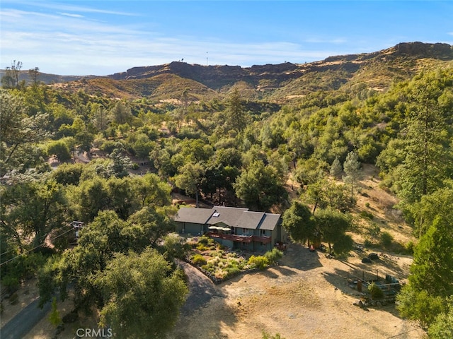 drone / aerial view with a mountain view and a wooded view