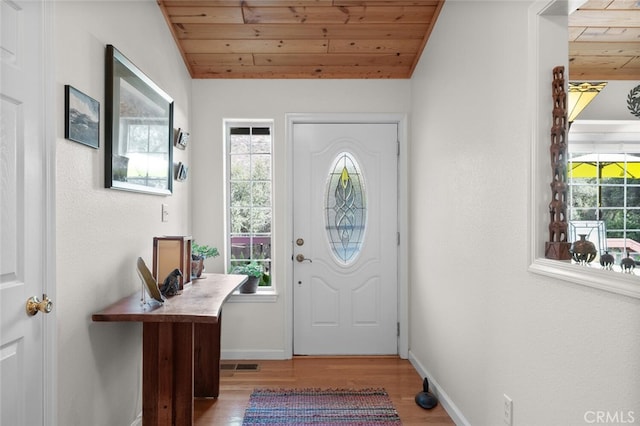 entryway featuring lofted ceiling, wooden ceiling, wood finished floors, and visible vents