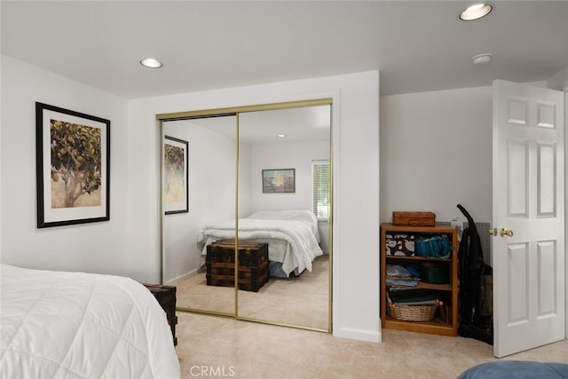 bedroom with a closet, carpet flooring, and recessed lighting