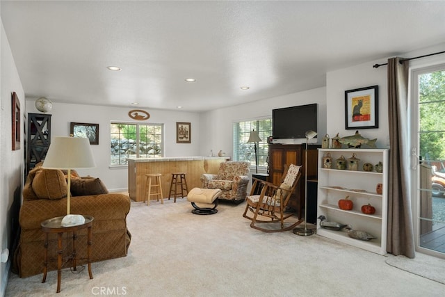 sitting room with a dry bar, carpet, and recessed lighting