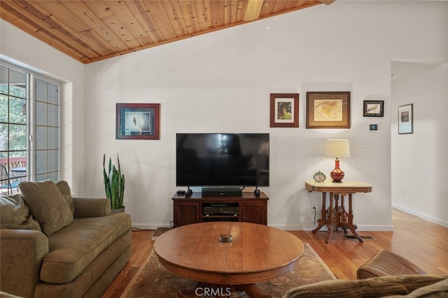 living room with lofted ceiling, wood ceiling, baseboards, and wood finished floors