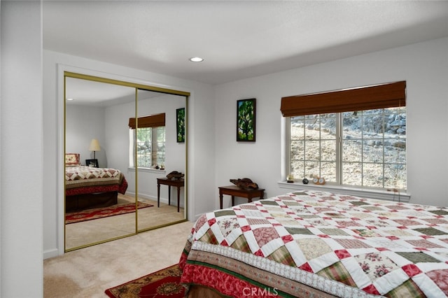 bedroom featuring a closet, baseboards, carpet flooring, and recessed lighting