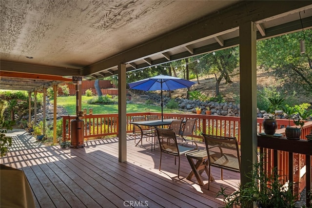 wooden terrace featuring outdoor dining space