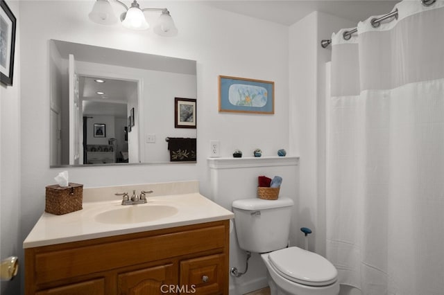 bathroom with a shower with shower curtain, vanity, and toilet