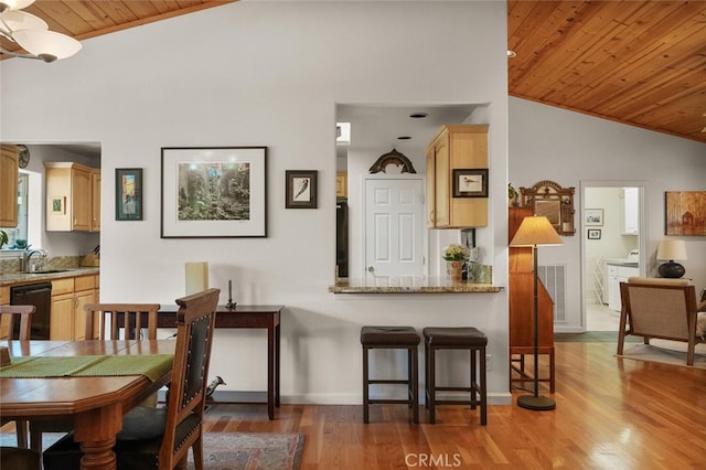 dining room with baseboards, visible vents, wood ceiling, wood finished floors, and vaulted ceiling