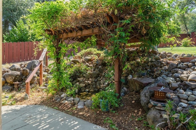 view of yard featuring fence and a patio