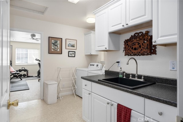 laundry area with light floors, cabinet space, washing machine and dryer, a sink, and ceiling fan