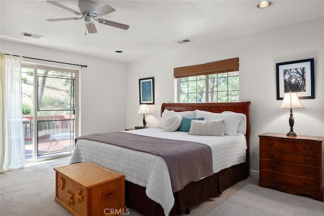 bedroom with light carpet, access to outside, visible vents, and a ceiling fan