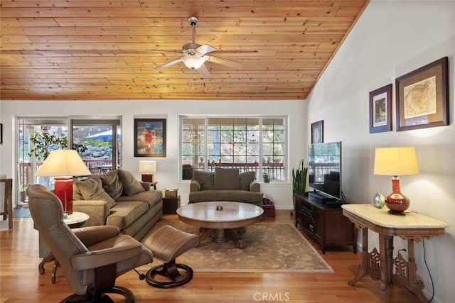 living room with wood ceiling, vaulted ceiling, light wood-style flooring, and ceiling fan