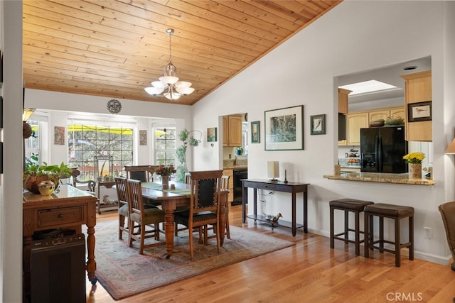 dining space featuring baseboards, wood ceiling, light wood-type flooring, high vaulted ceiling, and a notable chandelier