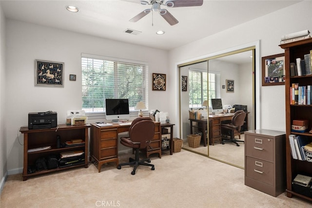 home office featuring light carpet, a wealth of natural light, visible vents, and recessed lighting