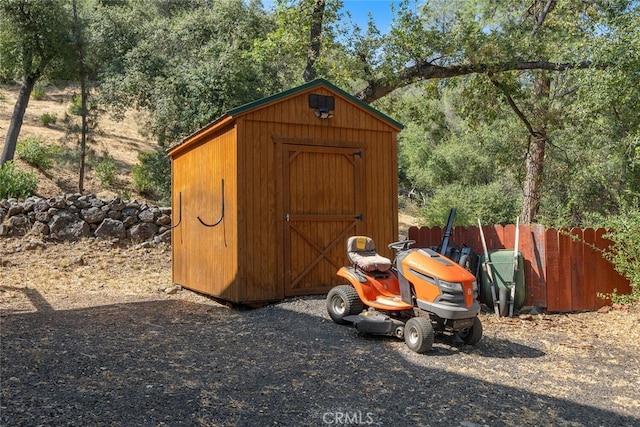 view of shed with fence