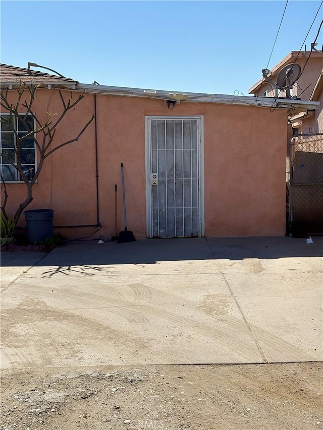 exterior space with a patio and stucco siding