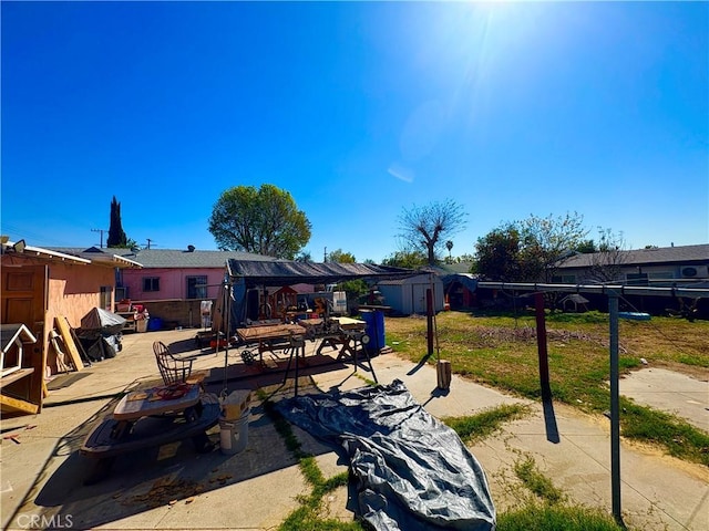 exterior space with fence, a storage unit, and an outdoor structure