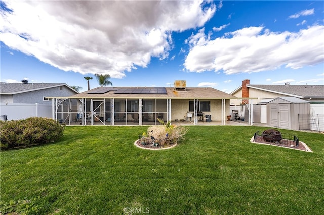26131 Chambers Ave, Menifee, CA 92586 - back of house featuring an outdoor fire pit, a patio area, solar panels, a shed, and a sunroom