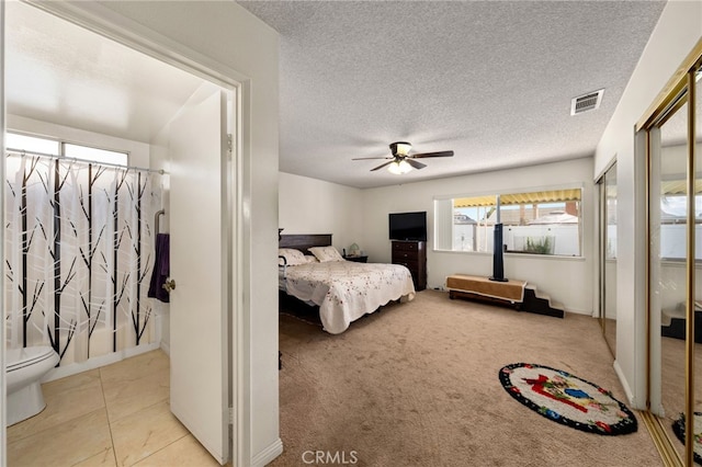 26131 Chambers Ave, Menifee, CA 92586 - carpeted bedroom with multiple windows, a textured ceiling, two closets, and ceiling fan