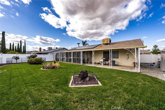 26131 Chambers Ave, Menifee, CA 92586 - rear view of house featuring a sunroom, an outdoor fire pit, stucco siding, a patio, and roof mounted solar panels