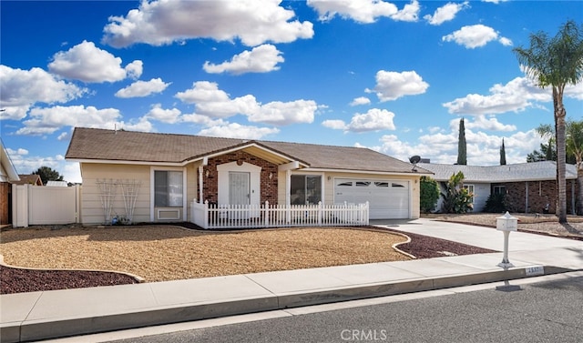 26131 Chambers Ave, Menifee, CA 92586 - ranch-style house with concrete driveway, an attached garage, a fenced front yard, and brick siding