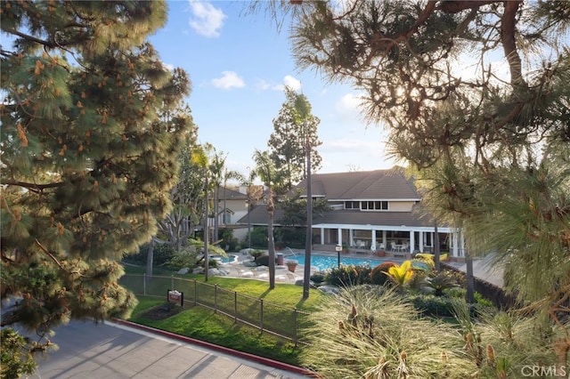 exterior space with a fenced in pool, a fenced backyard, a yard, and a patio