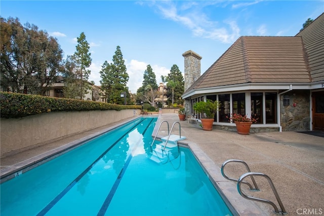 outdoor pool featuring a patio