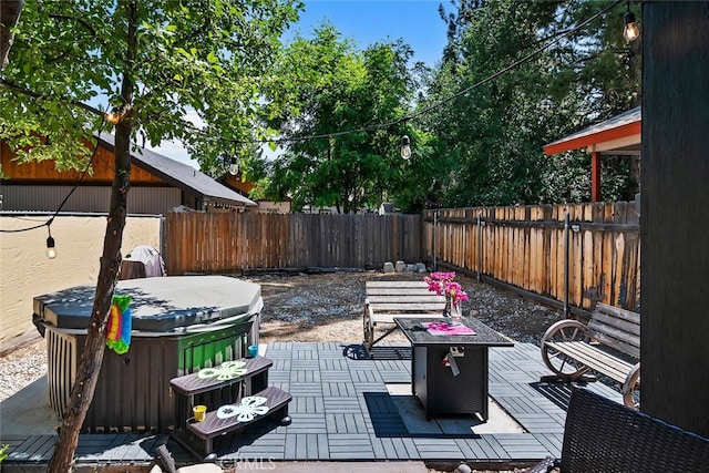 view of patio / terrace featuring a fenced backyard and a hot tub