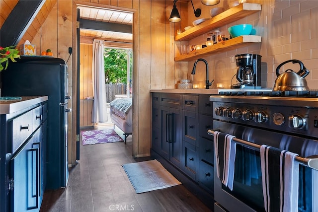 bar with wooden walls, tasteful backsplash, freestanding refrigerator, and high end stainless steel range