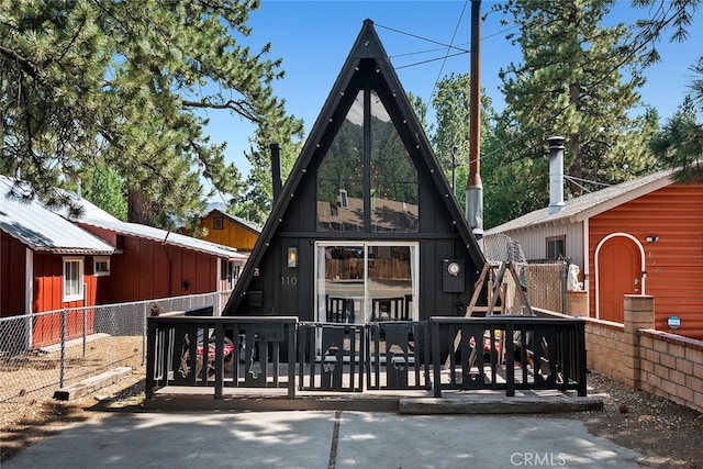 back of property featuring fence and a wooden deck