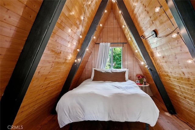 bedroom with wooden walls, wood ceiling, lofted ceiling with beams, and wood finished floors