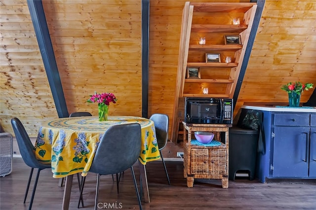 interior space featuring wooden walls and wood finished floors