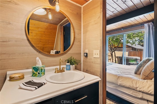 bathroom featuring vanity, wooden ceiling, and wood walls