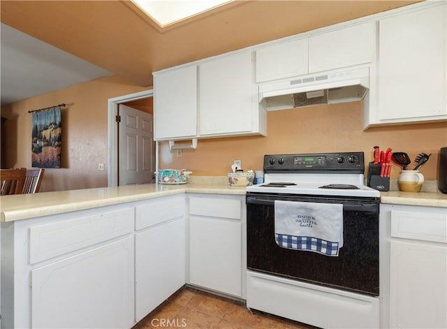 kitchen with a peninsula, light countertops, white cabinets, electric stove, and under cabinet range hood