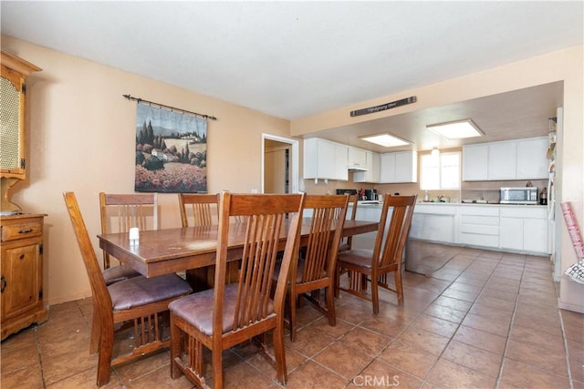 dining space featuring light tile patterned floors