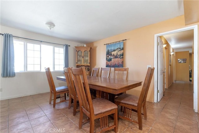 dining area with light tile patterned floors and baseboards