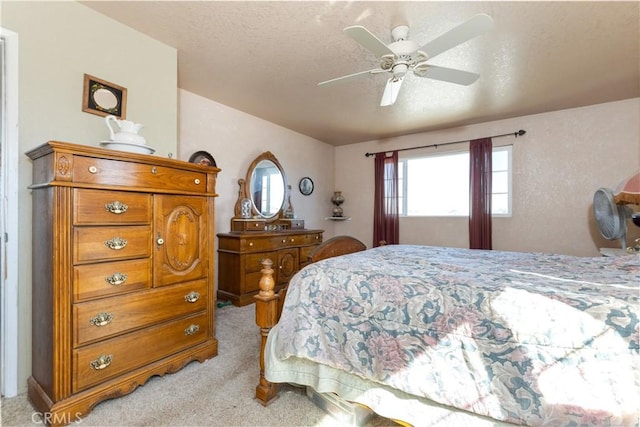 bedroom with light colored carpet, a textured ceiling, and a ceiling fan