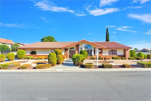 single story home with a tile roof and stucco siding