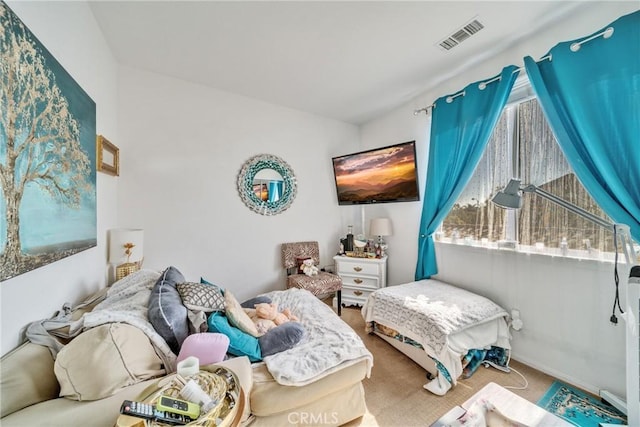 carpeted bedroom featuring visible vents