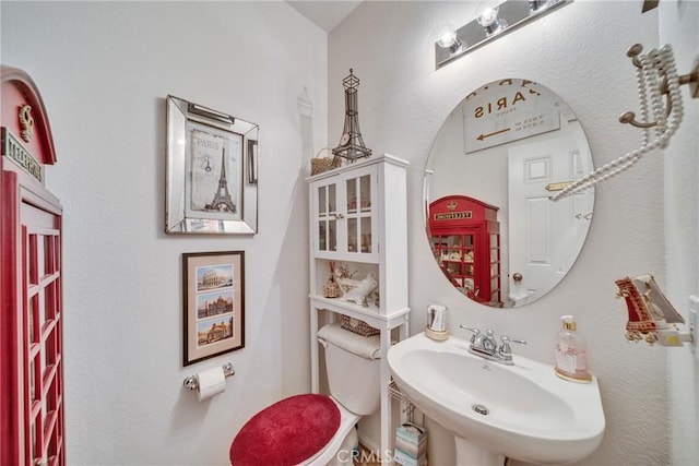 bathroom featuring toilet and a sink