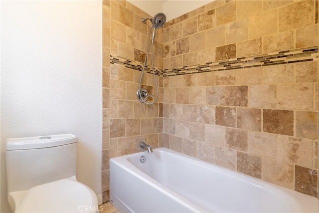 bathroom featuring shower / bathing tub combination and toilet