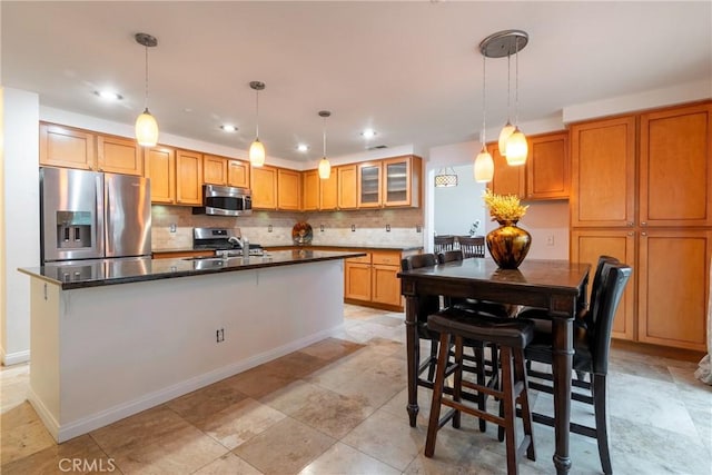 kitchen featuring a sink, tasteful backsplash, appliances with stainless steel finishes, and recessed lighting