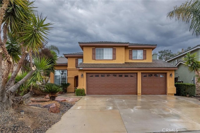 view of front of home featuring a tile roof, concrete driveway, a garage, and stucco siding