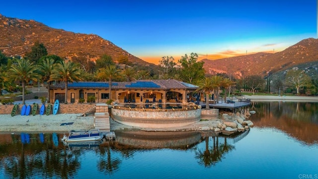 4065 Via Palo Verde Lago, Alpine, CA 91901 - back of property at dusk with solar panels and a water and mountain view