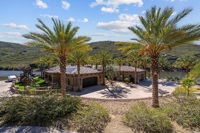 4065 Via Palo Verde Lago, Alpine, CA 91901 - mediterranean / spanish house with a garage, concrete driveway, a tiled roof, a water and mountain view, and stucco siding