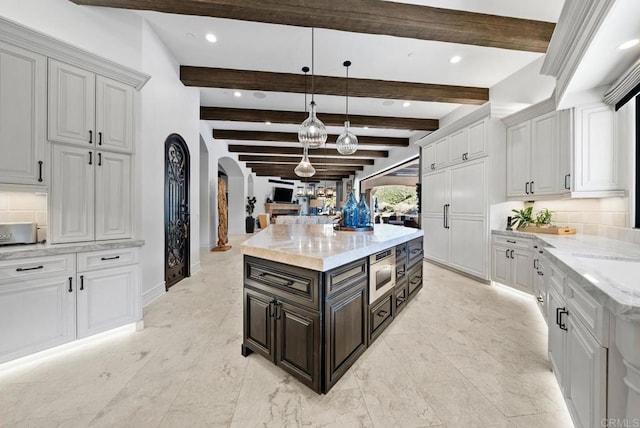 4065 Via Palo Verde Lago, Alpine, CA 91901 - kitchen with light stone counters, arched walkways, pendant lighting, tasteful backsplash, and white cabinetry