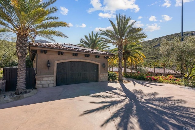 4065 Via Palo Verde Lago, Alpine, CA 91901 - view of front facade with a garage, concrete driveway, stone siding, a tiled roof, and stucco siding