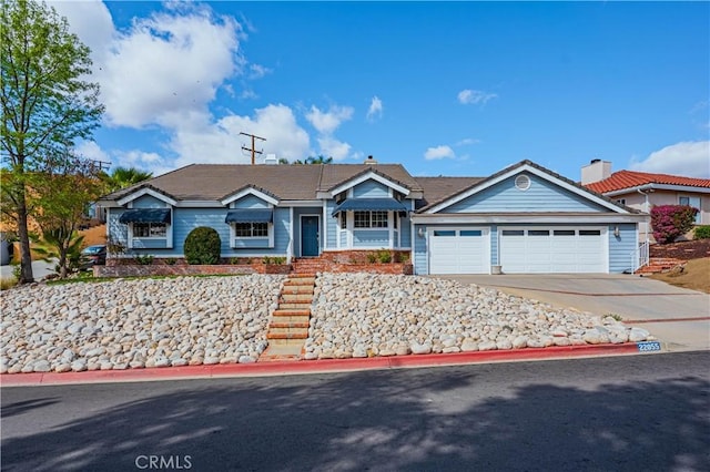 ranch-style home with a garage and concrete driveway