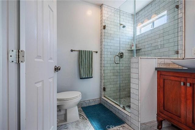 full bathroom with toilet, a shower stall, and vanity