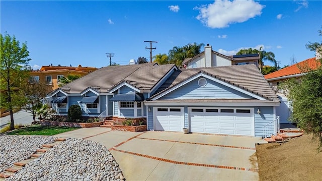 view of front of home featuring a garage, a tile roof, and concrete driveway