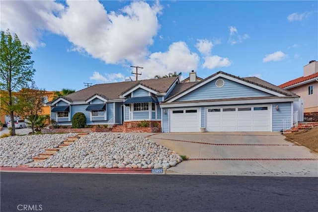 single story home featuring a garage, concrete driveway, a chimney, and a tiled roof